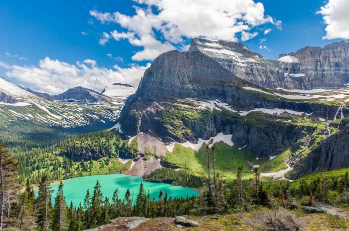 A turquoise lake at the base of giant mountains