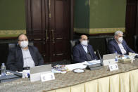 In this photo released by the official website of the office of the Iranian Presidency, cabinet members wearing face masks attend their meeting in Tehran, Iran, Wednesday, March 11, 2020. Senior Vice-President Eshaq Jahangiri and two other Cabinet members have contracted the new coronavirus, semiofficial Fars News Agency reported Wednesday. The vast majority of people recover from the new virus. (Iranian Presidency Office via AP)