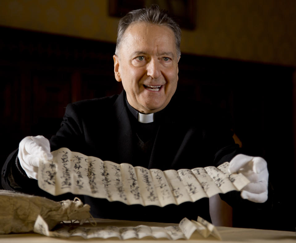 Prefect of the Vatican Apostolic Library Mons. Cesare Pasini shows Japanese manuscripts dating back to the 18th century recently found in the Vatican Library's archives during an interview with the Associated Press, at the Vatican Tuesday, Jan. 28, 2014. The Vatican library and four Japanese historical institutes have agreed to inventory, catalogue and digitize 10,000 documents from a lost Japanese archive detailing the crackdown on Christians in Japan in the 17th-19th centuries. Monsignor Cesare Pasini, head of the Vatican's Apostolic Library, said the so-called Marega Papers represent the largest known civic archive of its kind. An Italian missionary priest took the 22 bundles of documents out of Japan in the 1940s and brought them to Rome. They sat in the Vatican library's storage depository for decades until a Vatican researcher who could read the characters realized their importance in 2010. The six-year agreement signed Tuesday to inventory the documents and prepare them for study involves the National Institute of Japanese Literature and National Museum of Japanese History, among others. (AP Photo/Domenico Stinellis)