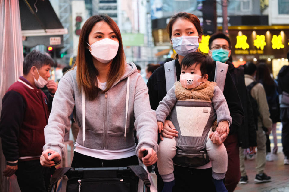 People wear protective mask and walk on the street on December 15, 2020 in Hong Kong, China.<span class="copyright">Sawayasu Tsuji–Getty Images</span>