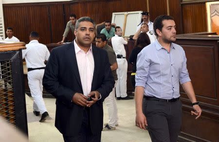 Al-Jazeera television journalists Mohamed Fahmy (L) and Baher Mohamed are seen at a court in Cairo after their retrial, April 22, 2015. REUTERS/Shadi Bushra