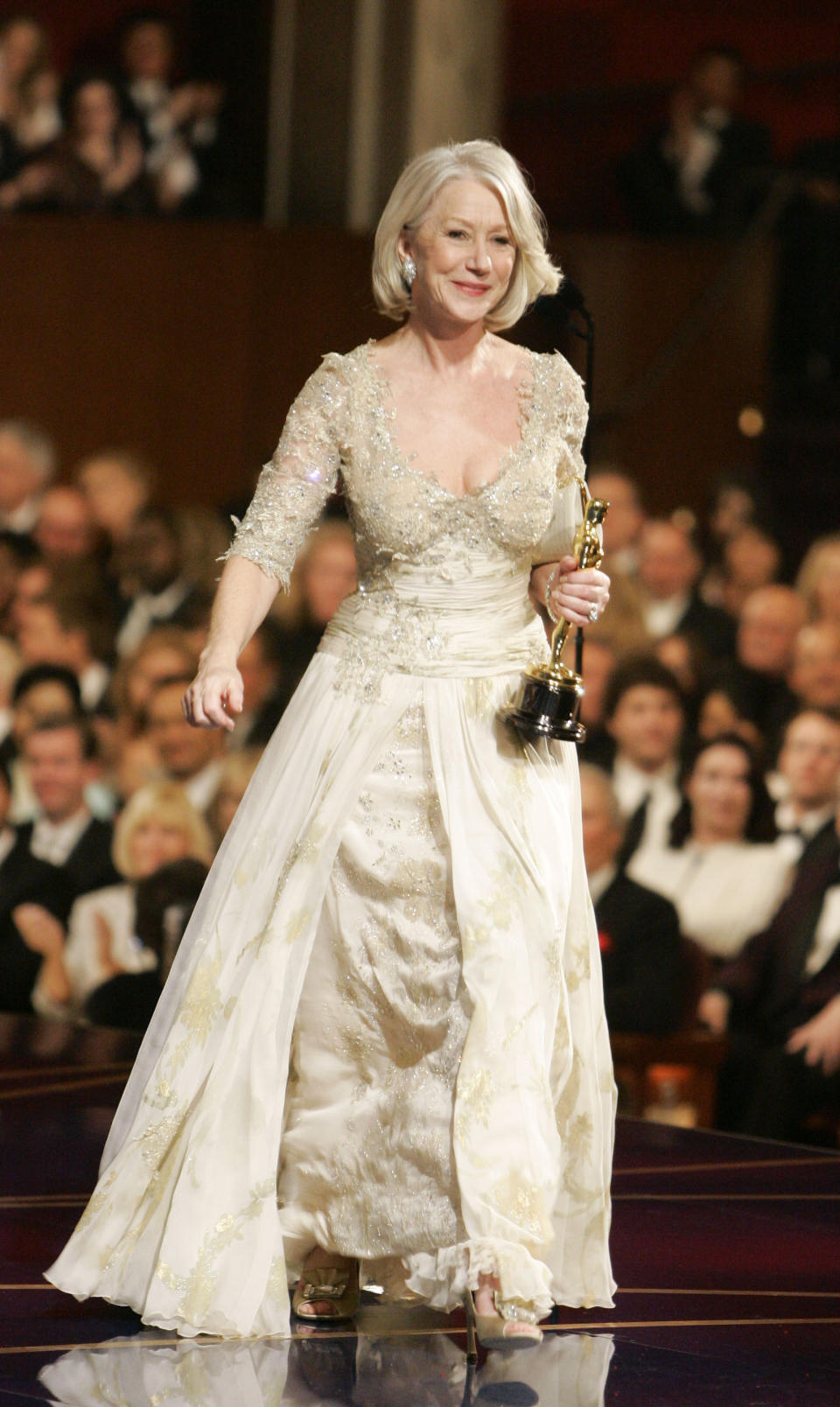 FILE - In this Feb. 25, 2007 file photo, British actress Helen Mirren accepts the Oscar for best actress for her work in "The Queen" at the 79th Academy Awards, in Los Angeles. The Academy Awards scene with Mirren accepting her Oscar is included in the Turner Classic Movies documentary “And the Oscar Goes To ...,” co-directed by Jeffrey Friedman and Robert Epstein, debuting Saturday, Feb. 1, 2014, at 8 p.m. EST on TCM. (AP Photo/Chris Carlson, File)