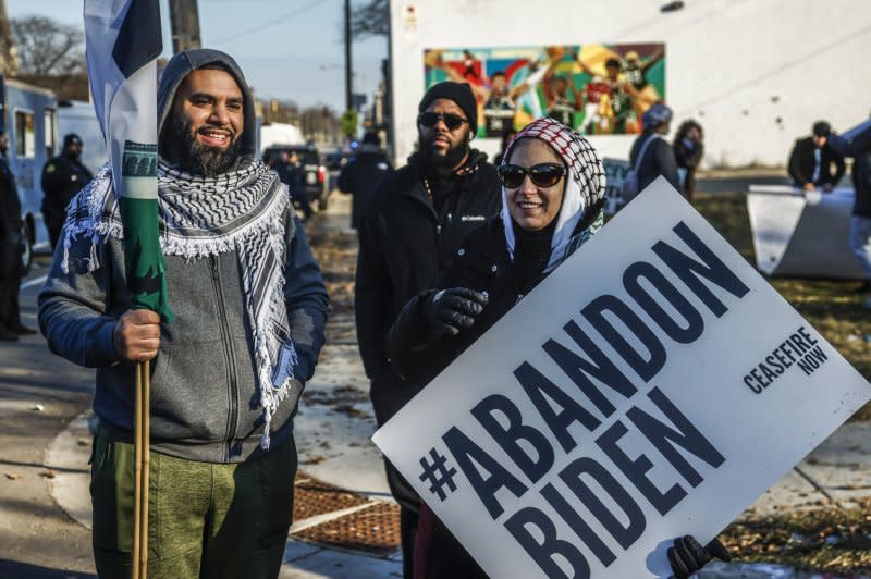 Pro-Palestine protesters hold signs and talk after US President Joe Biden spoke at the Wisconsin Black Chamber of Commerce in Milwaukee, Wisconsin on Wednesday, December 20, 2023. Biden made his third trip to Wisconsin this year to highlight his economic policies as he attempts to gain support from small and black owned business owners. Photo by Tannen Maury/UPI