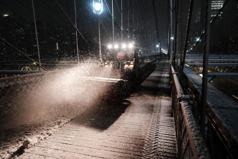 A snow plow clears a path along the Brooklyn Bridge during a storm on February 27, 2023 in New York City.