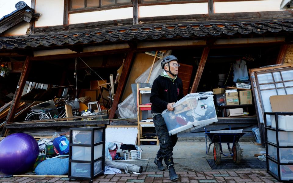 A resident of Nanao searches for his belongings