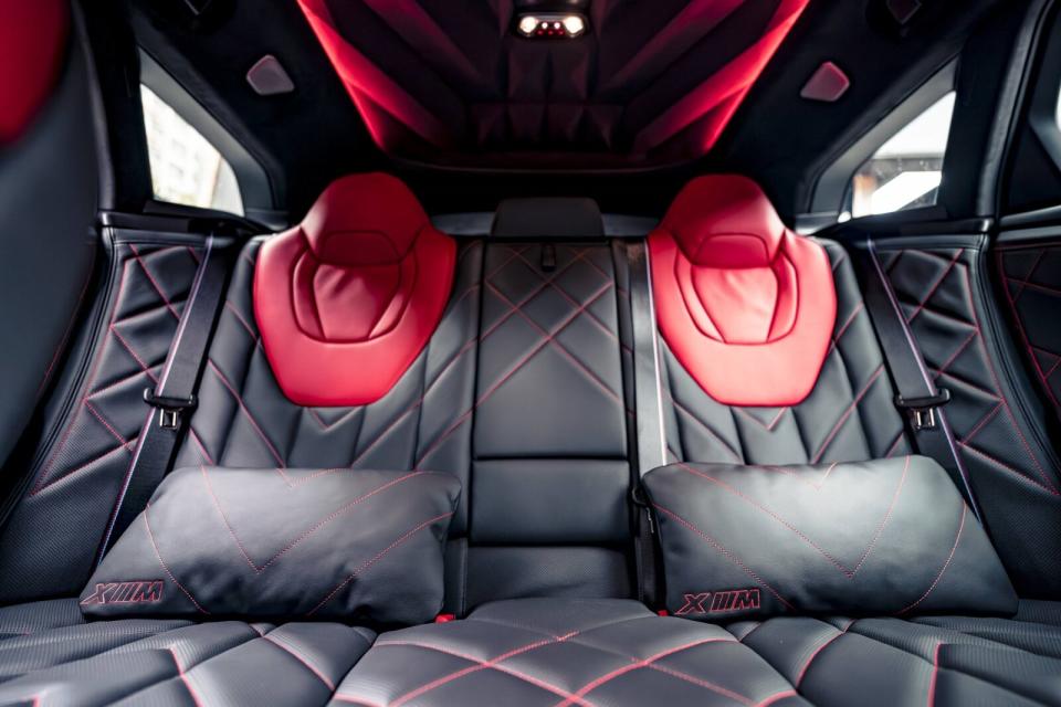 舒適寬闊的M Lounge後座座椅同樣採用紅色頭枕與縫線設計，兼顧奢華氣息與性能氛圍。