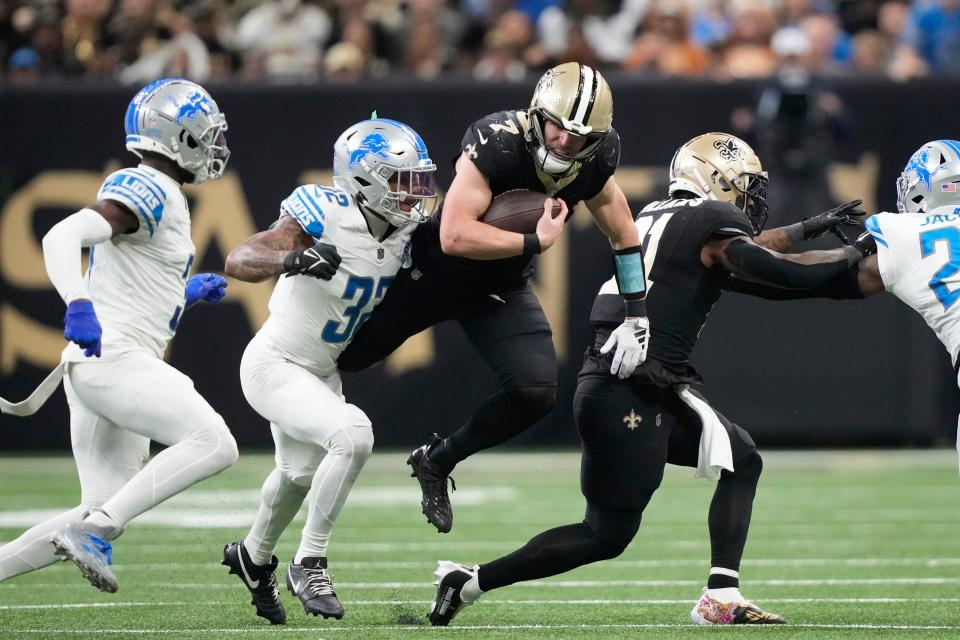 Saints quarterback Taysom Hill attempts to pull away from Lions safety Brian Branch during the second half of the Lions' 33-28 win on Sunday, Dec. 3, 2023, in New Orleans.