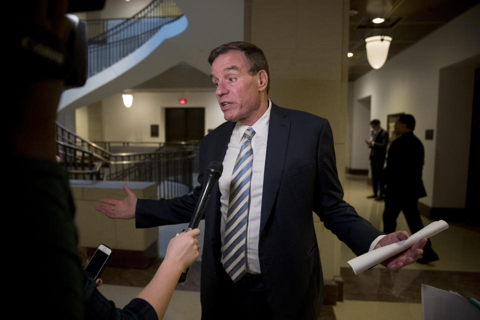 Sen. Mark Warner, D-Va., speaks with a reporter as he arrives at an event marking 100 days since the death of Jamal Khashoggi on Capitol Hill in Washington, Thursday, Jan. 10, 2019. (AP Photo/Andrew Harnik)