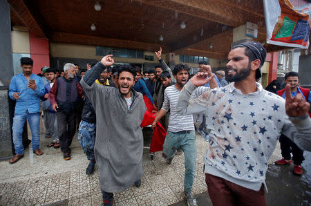 People shout slogans as they remove the body of a civilian on a stretcher, who according to local media reports was killed during clashes with Indian security forces near the site of a gunbattle between militants and Indian security forces in south Kashmir, at a hospital in Srinagar May 6, 2018. REUTERS/Danish Ismail