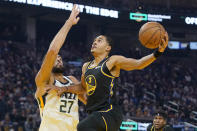 Golden State Warriors guard Jordan Poole (3) shoots against Utah Jazz center Rudy Gobert (27) during the first half of an NBA basketball game in San Francisco, Sunday, Jan. 23, 2022. (AP Photo/Jeff Chiu)