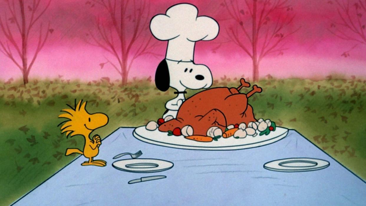 snoopy and woodstock prepare a thanksgiving table in a scene from a charlie brown thanksgiving