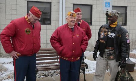 A group of retired military veterans gather to welcome back former U.S. Marine Amir Hekmati, recently released from an Iranian prison, arriving at an airport in Flint, Michigan January 21, 2016. REUTERS/Rebecca Cook