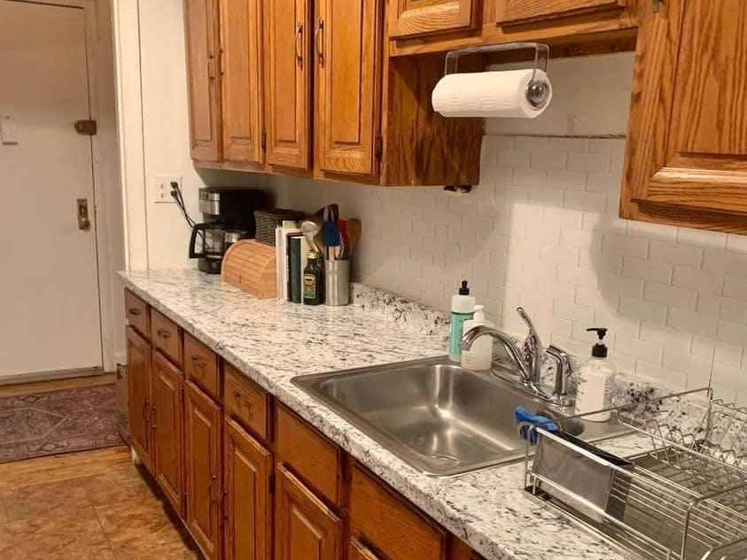 Wooden kitchen cabinets and drawers with a stone counter