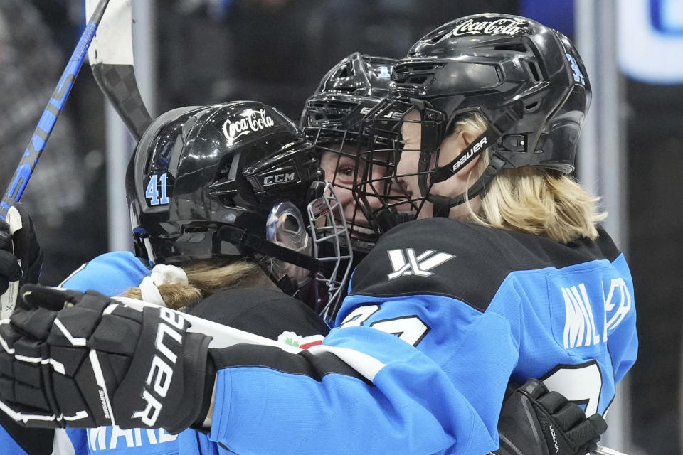 Toronto's Jesse Compher, center, celebrates with Brittany Howard, left, and Hannah Miller after scoring against Montreal during the third period of a PWHL hockey game Friday, Feb. 16, 2024, in Toronto. (Chris Young/The Canadian Press via AP)