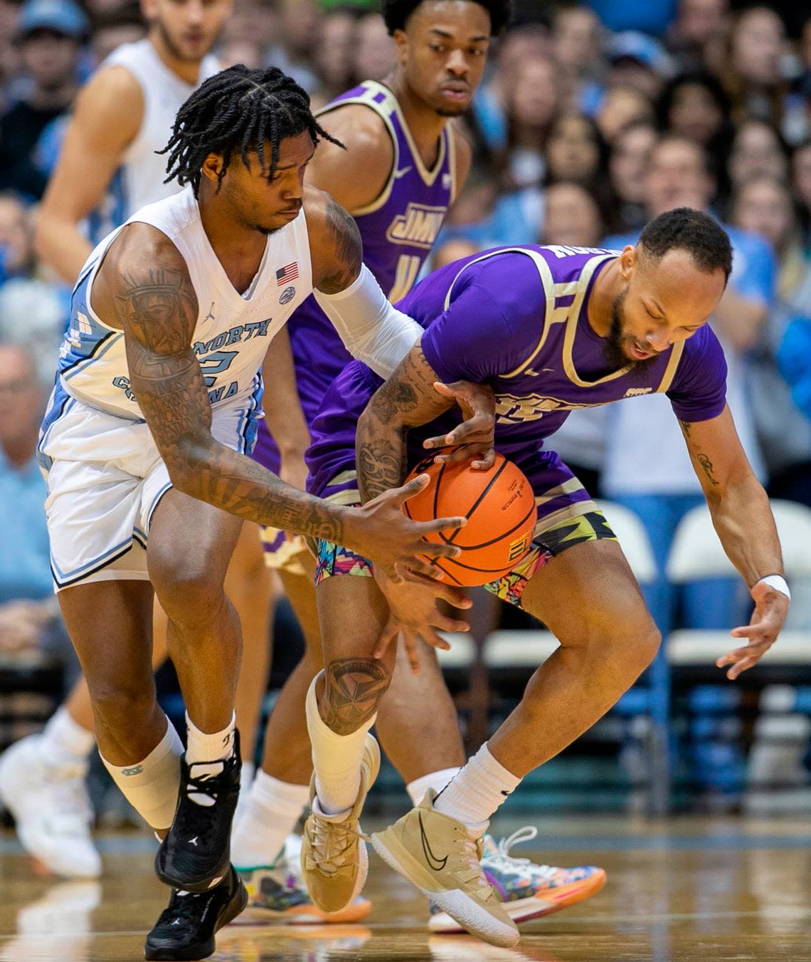 North Carolina’s Caleb Love (2) makes a steal from James Madison’s Takal Molson (15) in the first half on Sunday, November 20, 2022 at the Smith Center in Chapel Hill, N.C.