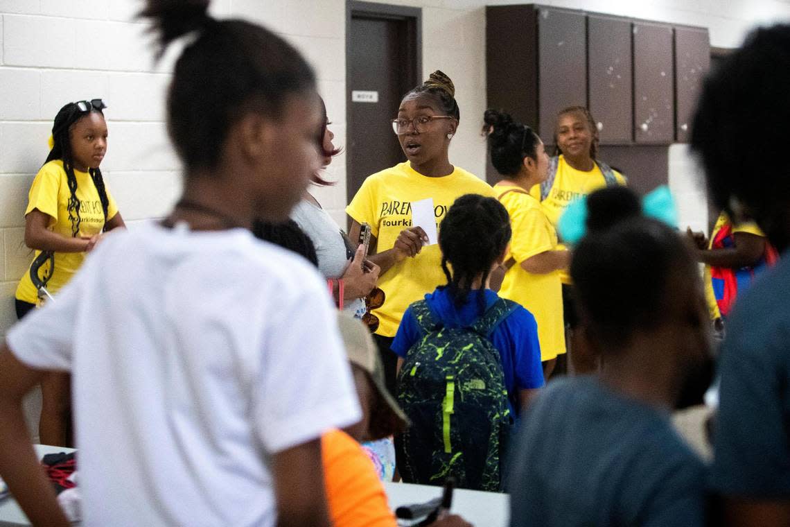 Trenace Dorsey-Hollins, a Powerful Parents Movement member, talks to another parent during a back-to-school fair about the state of schools in Fort Worth, Texas, on Saturday, Aug. 13, 2022.