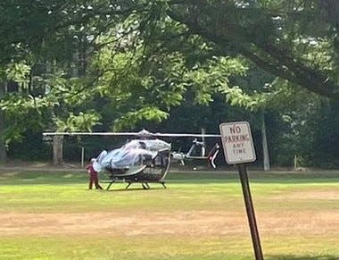 A medical rescue helicopter lands at Stone Park in Ashland on Thursday after a crash on Fountain Street, July 28, 2022. The helicopter transported a Natick woman to UMass-Memorial Medical Center in Worcester.