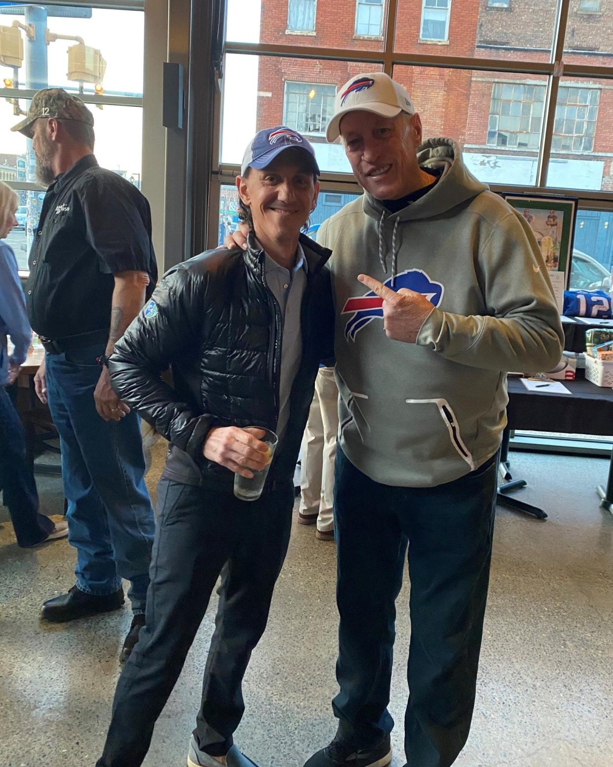 Greg Connors, left, with Buffalo Bills Hall of Fame quarterback Jim Kelly. Connors, a Hornell native and co-founder of the Connors & Ferris law firm, is a member of the board at the Hunter's Hope Foundation