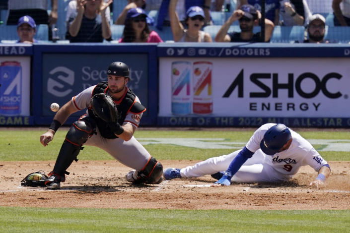 Los Angeles Dodgers' Gavin Lux, right, scores on a double by Max Muncy as San Francisco Giants catcher Joey Bart takes a late throw during the third inning of a baseball game Sunday, July 24, 2022, in Los Angeles. (AP Photo/Mark J. Terrill)