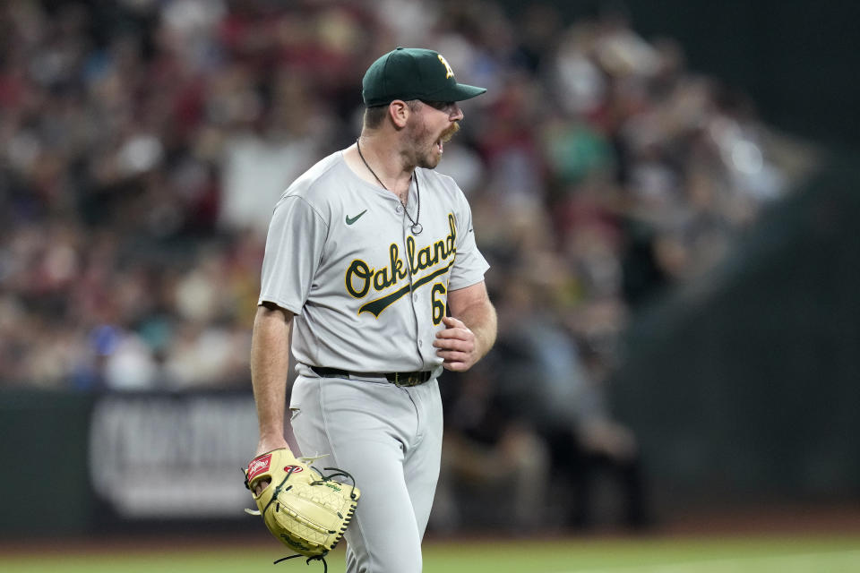 Oakland Athletics starting pitcher Hogan Harris shouts after an infield single by Arizona Diamondbacks' Ketel Marte during the fourth inning of a baseball game Saturday, June 29, 2024, in Phoenix. (AP Photo/Ross D. Franklin)