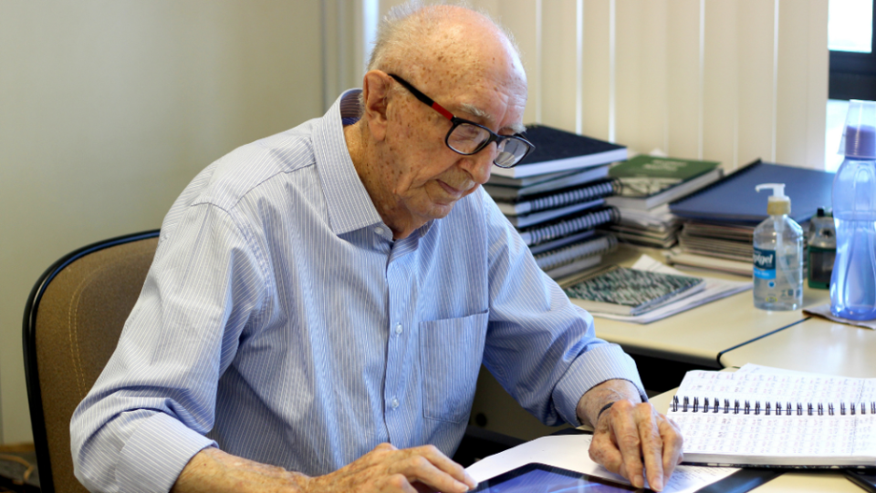 Walter Orthmann, who is 100 years old, is seen working in his office.