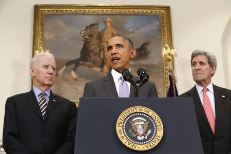 U.S. President Barack Obama is flanked by Vice President Joe Biden (L) and Secretary of State John Kerry (R) as he delivers a statement on legislation sent to Congress to authorize the use of military force against the Islamic State, from the Roosevelt Room at the White House in Washington February 11, 2015. REUTERS/Jonathan Ernst