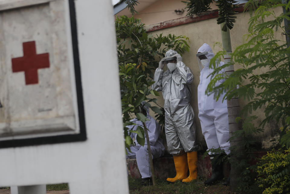 Sri Lankan health workers prepare to collect swab samples from people to test for COVID-19 outside a hospital in Minuwangoda, Sri Lanka, Tuesday, Oct. 6, 2020. (AP Photo/Eranga Jayawardena)