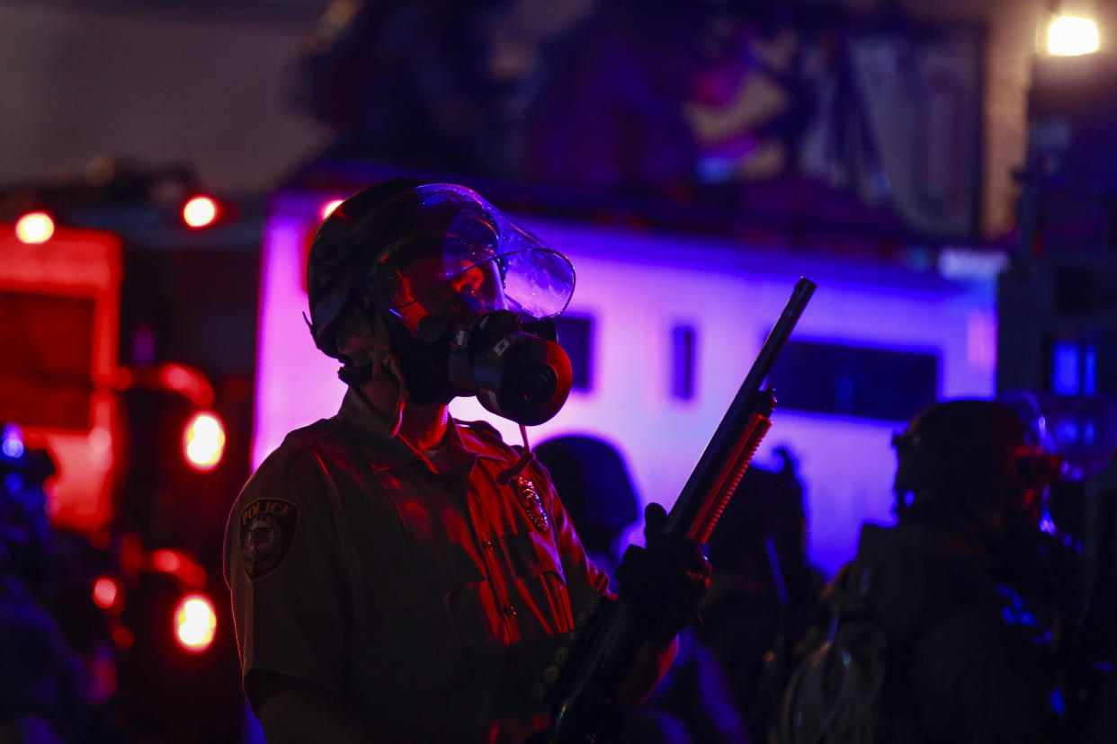 Police forces stand at the ready in Ferguson, Missouri, as protesters take the streets to protest the killing of Michael Brown in 2014, shortly after Missouri Gov. Jay Nixon declared a curfew and a state of emergency. (Photo: Anadolu Agency/Getty Images)