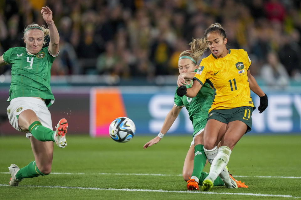 Australia's Mary Fowler, right, vies for the ball with Ireland's Ruesha Littlejohn, center, and Louise Quinn during the Women's World Cup soccer match between Australia and Ireland at Stadium Australia in Sydney, Australia, Thursday, July 20, 2023. (AP Photo/Rick Rycroft)