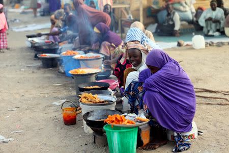 FILE PHOTO: Internally displaced women vendors fry beans cake at a village camp in Maiduguri, Nigeria, February 16, 2019. REUTERS/Afolabi Sotunde