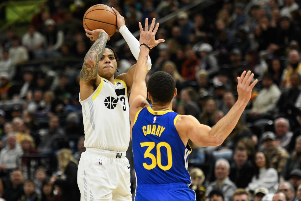 SALT LAKE CITY, UTAH - FEBRUARY 15: Keyonte George #3 of the Utah Jazz shoots over Stephen Curry #30 of the Golden State Warriors during the second half of a game at Delta Center on February 15, 2024 in Salt Lake City, Utah. NOTE TO USER: User expressly acknowledges and agrees that, by downloading and or using this photograph, User is consenting to the terms and conditions of the Getty Images License Agreement. (Photo by Alex Goodlett/Getty Images)