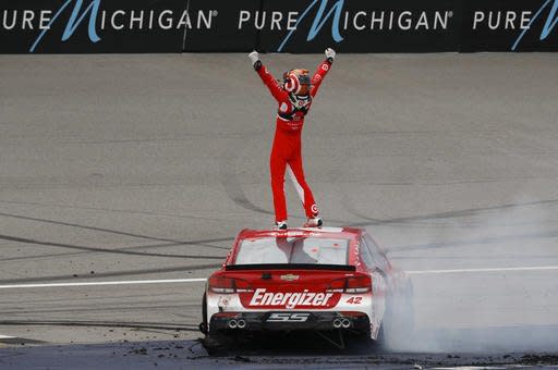 Kyle Larson celebrates winning the NASCAR Sprint Cup Series auto race at Michigan International Speedway, in Brooklyn, Mich., Sunday, Aug. 28, 2016. (AP Photo/Paul Sancya)