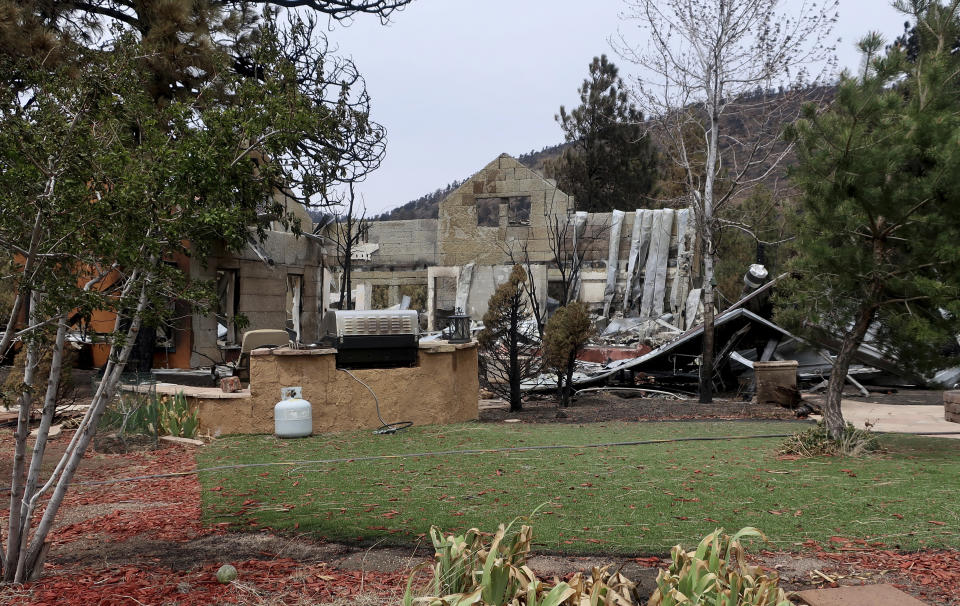 This photograph taken Tuesday, April 26, 2022, shows the erratic nature of a wildfire that destroyed the home of Jeanne and Mike Welnick outside Flagstaff, Ariz., but spared other areas of their property. The blaze that started Easter Sunday burned about 30 square miles and more than a dozen homes, hopscotching across the parched landscape. (AP Photo/Felicia Fonseca)