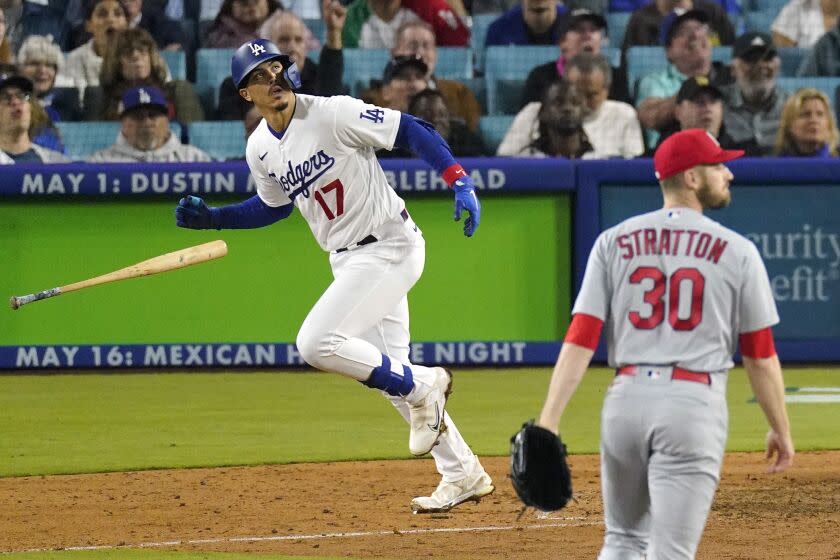 Los Angeles Dodgers' Miguel Vargas, left, heads t first after hitting a two-run home run as St. Louis Cardinals.