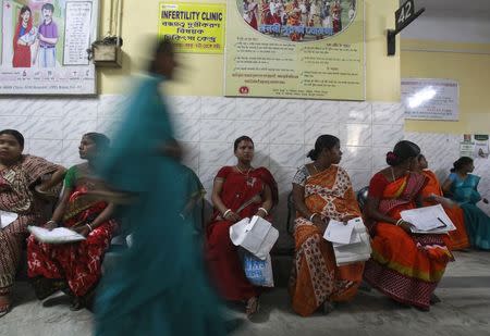 Pregnant women holding their prescription papers wait to be examined at a government-run hospital in the northeastern Indian city of Agartala March 17, 2015. REUTERS/Jayanta Dey