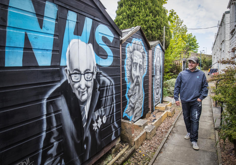 Artist Symon Mathieson alongside the mural he painted in tribute to Captain Tom and the NHS on a garden shed in Dundee centre, as the UK continues in lockdown to help curb the spread of the coronavirus.