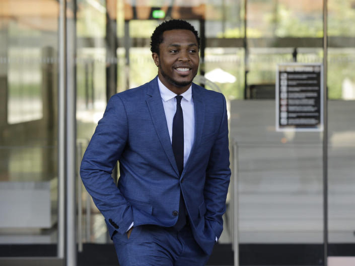 Rapper Marcus Gray smiles as he leaves the federal courthouse in Los Angeles Thursday, Aug. 1, 2019. A jury has decided that Katy Perry, her collaborators and her record label must pay more than $2.78 million because the pop star's 2013 hit "Dark Horse" copied a Christian rap song. It was an underdog victory for relatively obscure artist Gray, whose 5-year-old lawsuit survived constant court challenges. (AP Photo/Damian Dovarganes)
