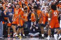 Illinois forward Coleman Hawkins (33) and guards Jayden Epps, center left, and Sencire Harris celebrate during the second half of the team's NCAA college basketball game against UCLA on Friday, Nov. 18, 2022, in Las Vegas. (AP Photo/Chase Stevens)