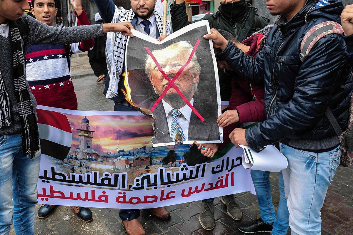 Palestinian protesters prepare to burn a picture of Donald Trump in the southern Gaza Strip town of Rafah: AFP/Getty Images