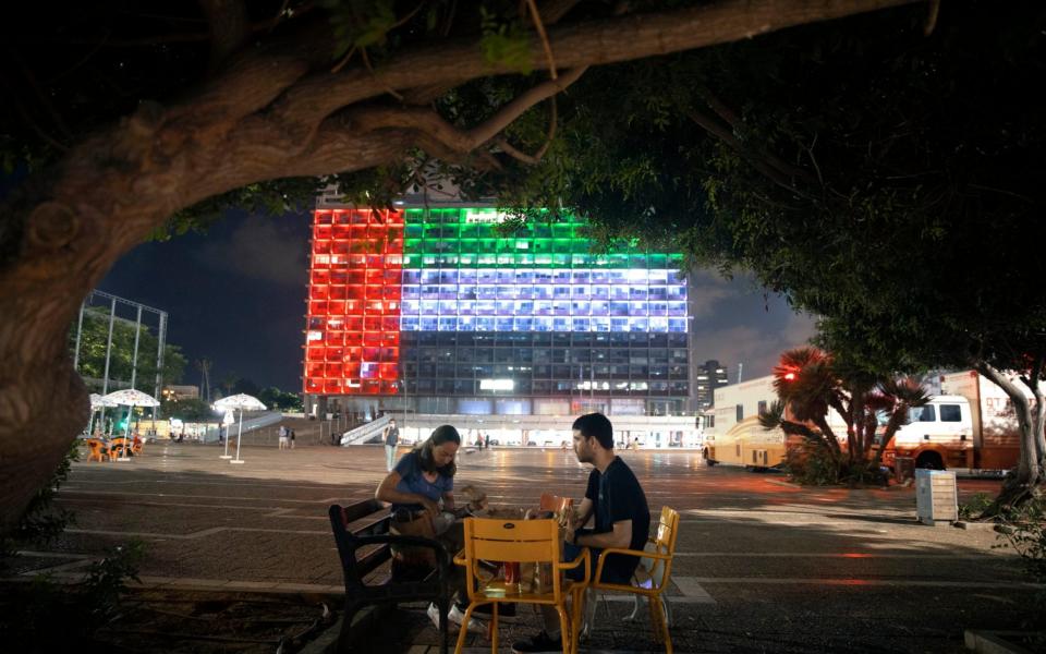 Tel Aviv City Hall is lit up with the flags of the United Arab Emirates and Israel as the countries announced they would be establishing full diplomatic ties, - AP