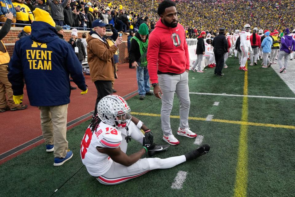 Ohio State receiver Marvin Harrison Jr. sits on the sideline as time expires in Saturday's loss at Michigan.