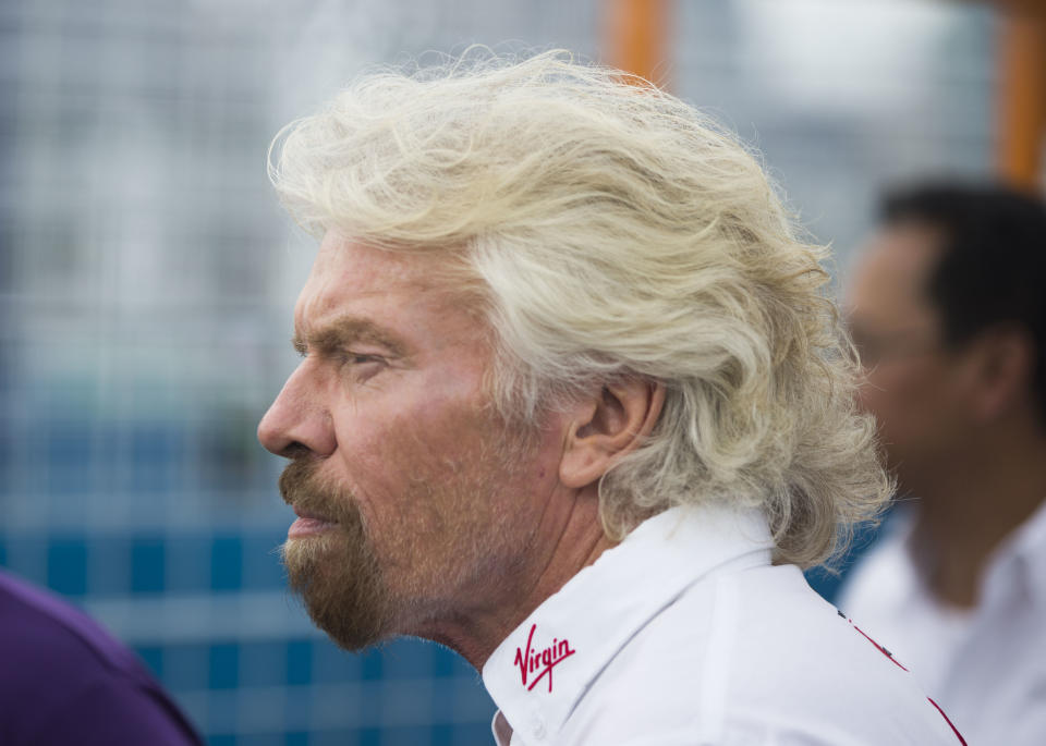 Virgin Group founder Richard Branson approaches the winner’s circle after team driver Sam Bird won the New York City ePrix a Formula E all-electric auto race Saturday, July 15, 2017, in the Brooklyn borough of New York. (AP Photo/Michael Noble Jr.)