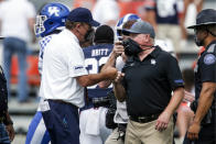 Auburn head coach Gus Malzahn, left, and Kentucky head coach Mark Stoops fist bump after an NCAA college football game on Saturday, Sept. 26, 2020, in Auburn, Alabama. Auburn won 29-13. (AP Photo/Butch Dill)