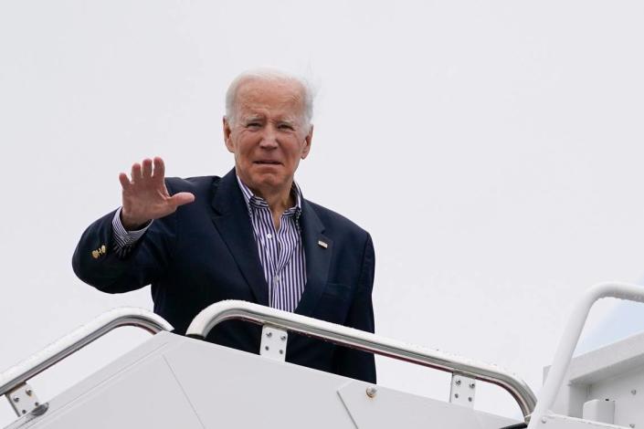 President Joe Biden waves before boarding Air Force One for a trip to Florida to visit areas impacted by Hurricane Ian, Wednesday, Oct. 5, 2022, in Andrews Air Force Base, Md. (AP Photo/Evan Vucci)