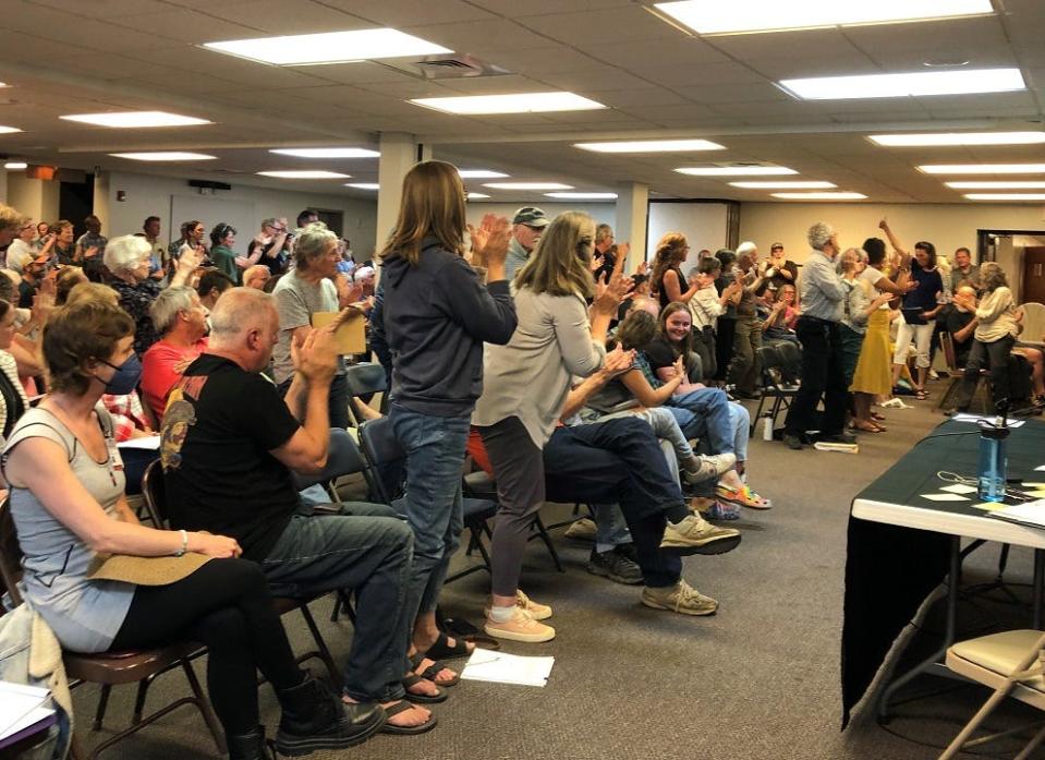 Several residents stand and applaud Granville Mayor Melissa Hartfield after her comments against two proposed asphalt plants in Alexandria during a public hearing June 8.