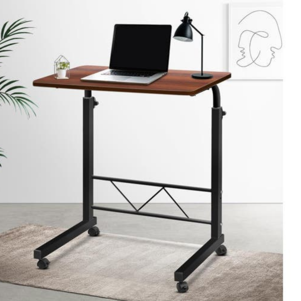 Portable desk from Amazon, with a laptop and lamp on top. 