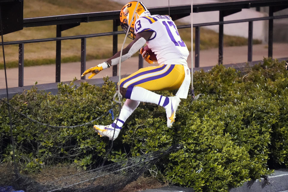 LSU wide receiver Jontre Kirklin jumps into a hedge after scoring a touchdown against Vanderbilt in the second half of an NCAA college football game Saturday, Oct. 3, 2020, in Nashville, Tenn. LSU won 41-7. (AP Photo/Mark Humphrey)