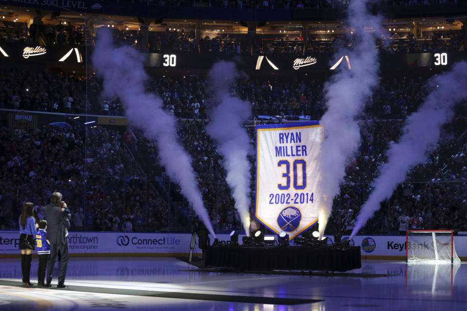 Former Buffalo Sabres goaltender Ryan Miller and his family watch as a banner with his name and number is raised to the rafters before an NHL hockey game between the Sabres and the New York Islanders on Thursday, Jan. 19, 2023, in Buffalo, N.Y. (AP Photo/Joshua Bessex)