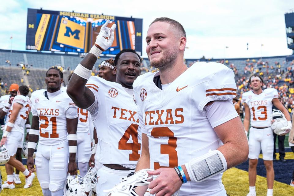 Texas quarterback Quinn Ewers celebrates with teammates after their 31-12 win over Michigan last Saturday, which helped propel Ewers to front-runner status in the Heisman Trophy race. On Thursday, UT coach Steve Sarkisian said he's not worried about any Heisman hype affecting Ewers.