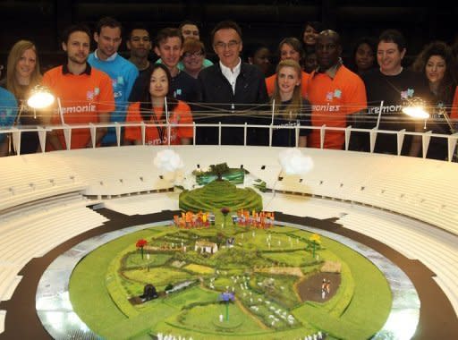 Image provided by the London Organising Committee of the Olympic and Paralympic Games shows British director Danny Boyle (C) looking at a model of the set being built in London's Olympic Stadium for the opening ceremony. The pastoral set of meadows has stumped commentators, drawing comparisons to the children's show "Teletubbies"